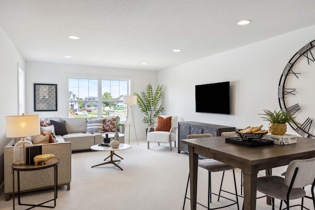 carpeted living room featuring a textured ceiling