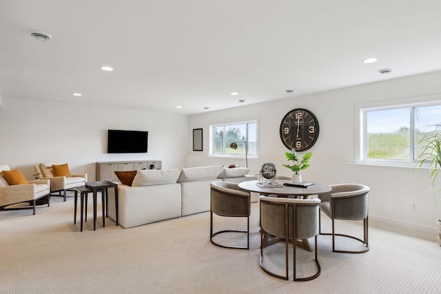 carpeted dining room with a wealth of natural light