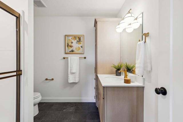 bathroom featuring vanity, tile patterned flooring, and toilet