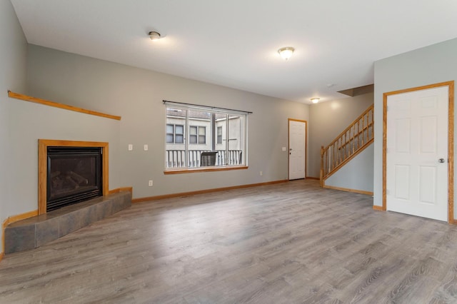 unfurnished living room with light hardwood / wood-style flooring and a fireplace