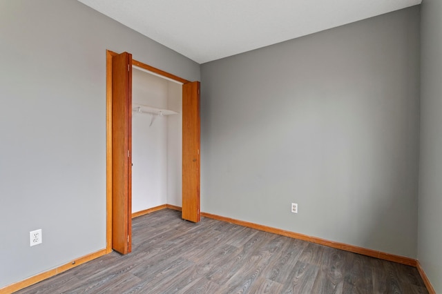 unfurnished bedroom with a closet and light hardwood / wood-style flooring