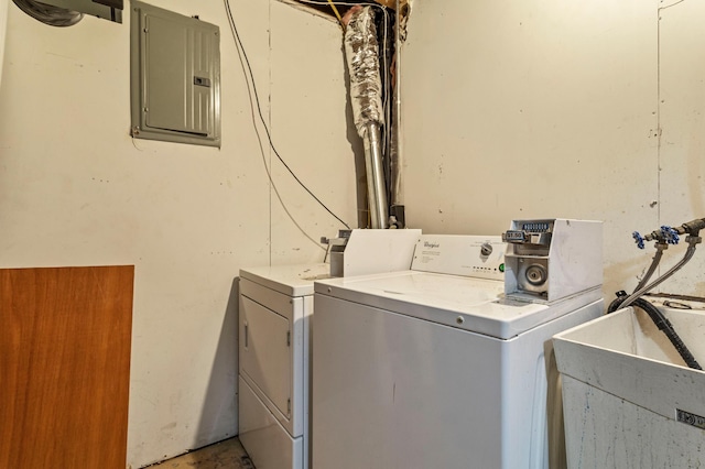 washroom with electric panel, sink, and independent washer and dryer