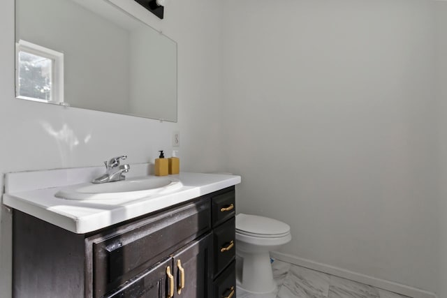 bathroom featuring toilet and vanity