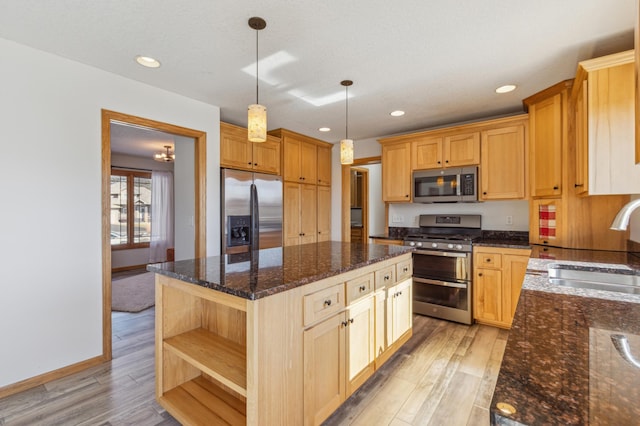 kitchen with open shelves, light wood-style flooring, a sink, stainless steel appliances, and a center island