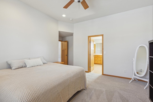 bedroom featuring baseboards, light colored carpet, recessed lighting, ensuite bath, and a ceiling fan