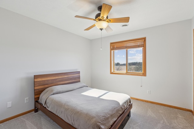 bedroom featuring visible vents, a ceiling fan, baseboards, and carpet floors