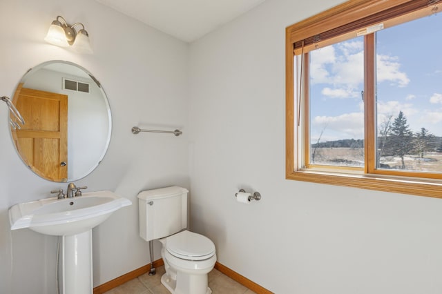 bathroom with tile patterned floors, visible vents, toilet, and baseboards