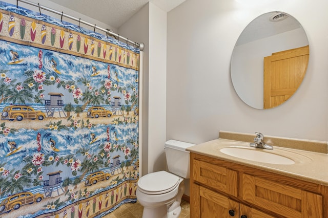 bathroom featuring tile patterned flooring, curtained shower, toilet, vanity, and a textured ceiling