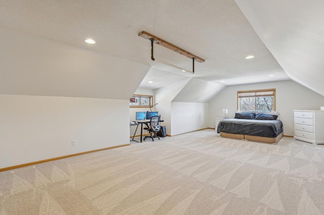 unfurnished bedroom with baseboards, lofted ceiling, carpet floors, and a textured ceiling