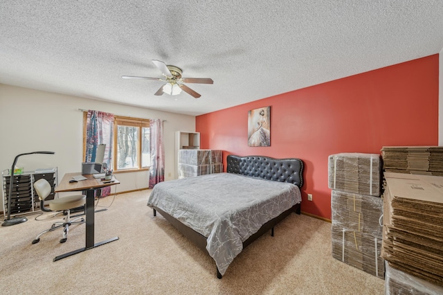 bedroom featuring light carpet, a textured ceiling, a ceiling fan, and baseboards