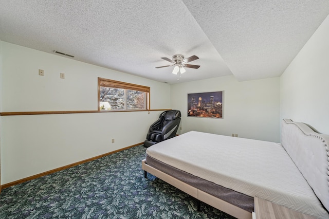 bedroom with a textured ceiling, carpet flooring, a ceiling fan, visible vents, and baseboards