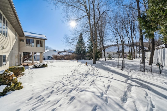 snowy yard featuring stairway