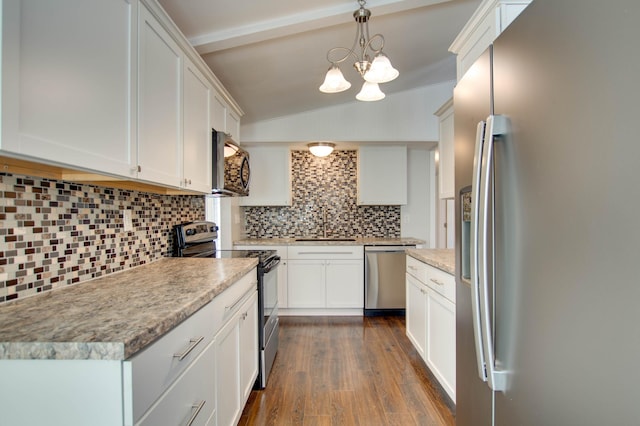 kitchen featuring dark hardwood / wood-style floors, white cabinets, decorative backsplash, hanging light fixtures, and stainless steel appliances