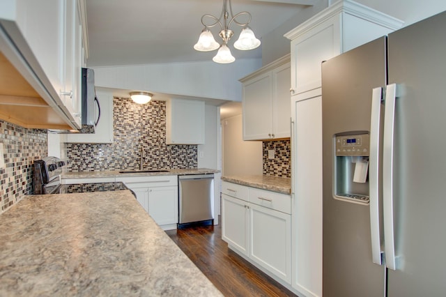 kitchen with white cabinetry, appliances with stainless steel finishes, sink, and decorative light fixtures