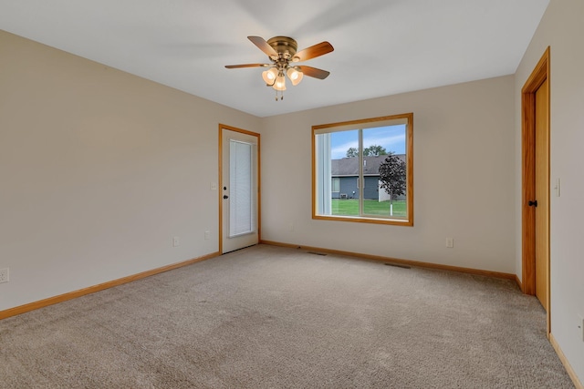 611 Cottonwood Ave, Litchfield, MN 55355 - unfurnished room with light carpet, baseboards, and a ceiling fan