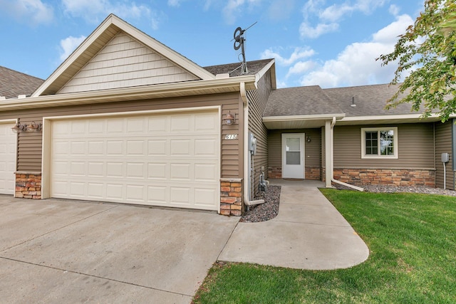 615 Cottonwood Ave, Litchfield, MN 55355 - view of front of home featuring a garage, stone siding, a shingled roof, and driveway
