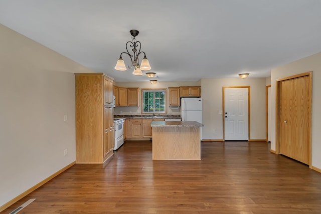 615 Cottonwood Ave, Litchfield, MN 55355 - kitchen with white appliances, dark wood finished floors, a kitchen island, a sink, and a chandelier
