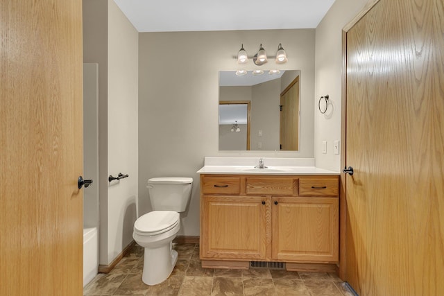 615 Cottonwood Ave, Litchfield, MN 55355 - bathroom with toilet, vanity, and baseboards