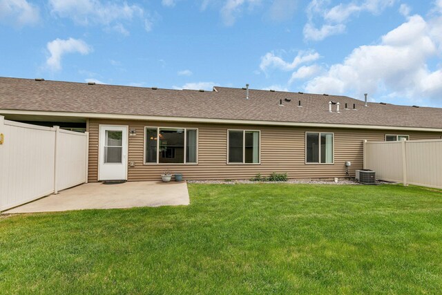 615 Cottonwood Ave, Litchfield, MN 55355 - back of property with a patio area, central AC, and roof with shingles