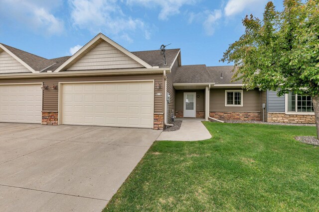 615 Cottonwood Ave, Litchfield, MN 55355 - view of front of property with driveway, stone siding, a front yard, and an attached garage