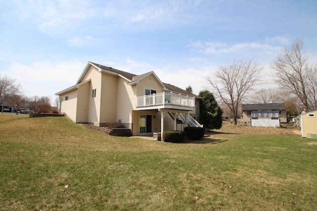rear view of house with stairway, a deck, a patio, and a lawn