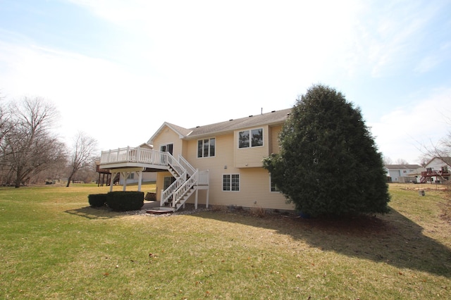 back of house featuring crawl space, stairway, a deck, and a lawn