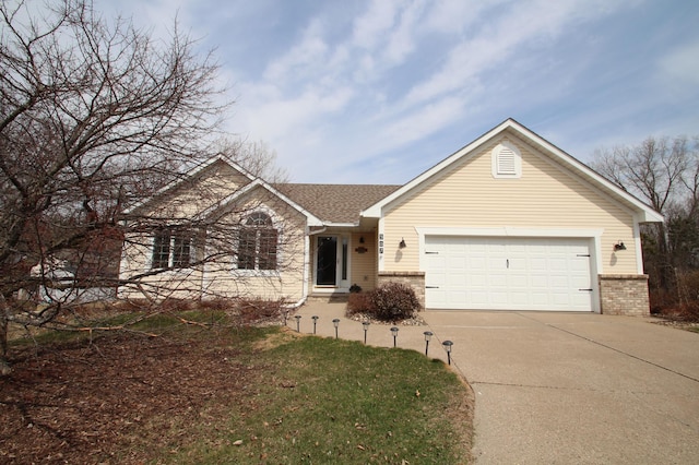 single story home featuring an attached garage, a shingled roof, concrete driveway, and brick siding
