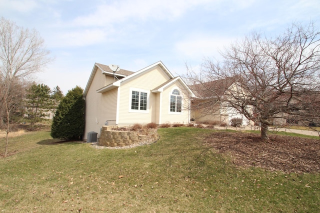 view of side of home with a lawn