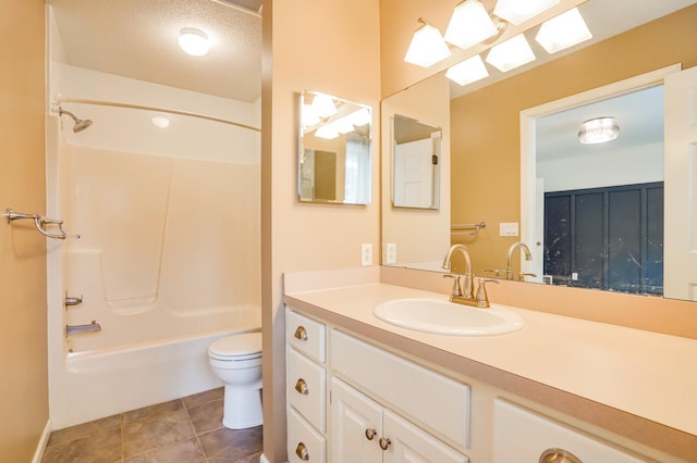 bathroom featuring tile patterned floors, vanity, shower / tub combination, and toilet