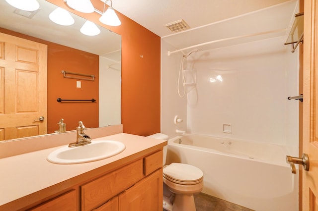 bathroom featuring toilet, vanity, washtub / shower combination, and visible vents