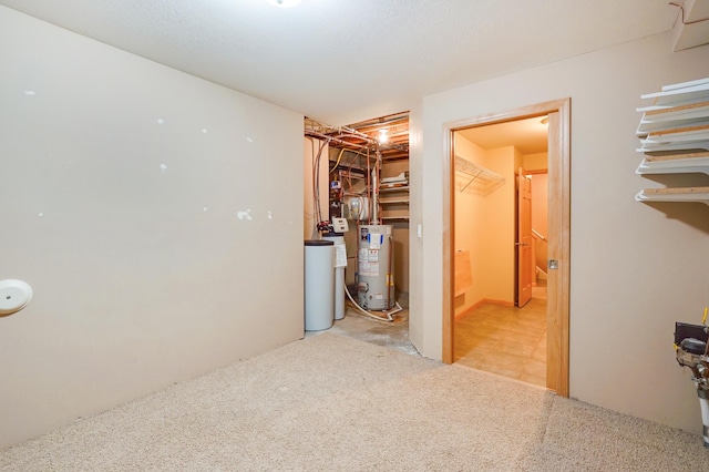 basement with water heater and carpet floors