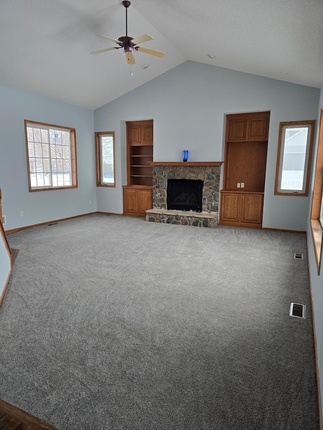 unfurnished living room with carpet flooring, a fireplace, ceiling fan, and vaulted ceiling