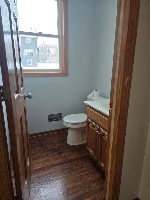 bathroom featuring hardwood / wood-style flooring, vanity, and toilet