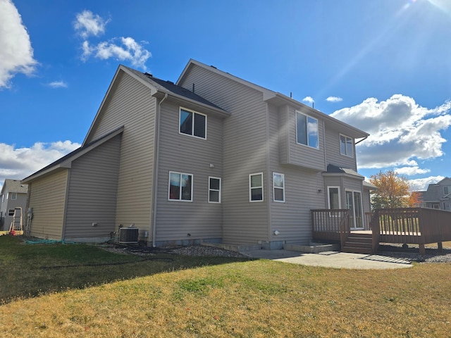 rear view of house with a yard, central AC, and a deck