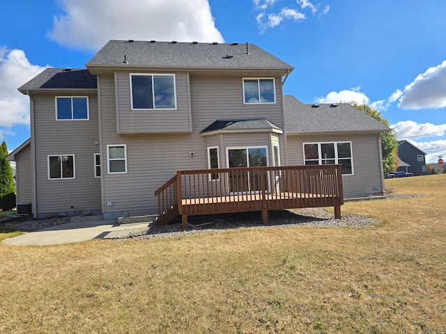 rear view of property featuring a wooden deck, central AC unit, a patio area, and a lawn