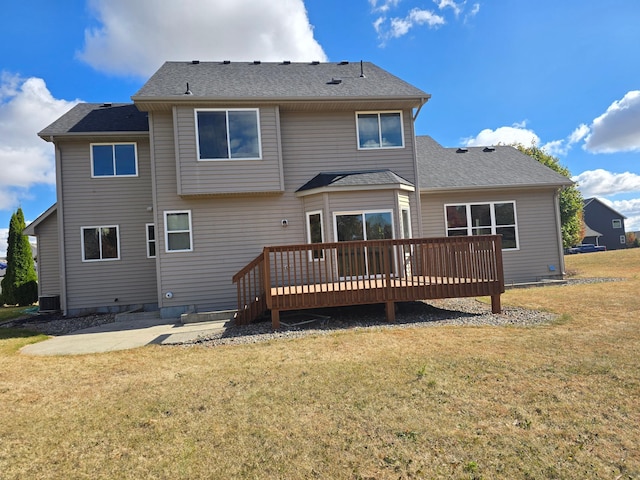 back of property featuring a wooden deck, a patio, and a lawn