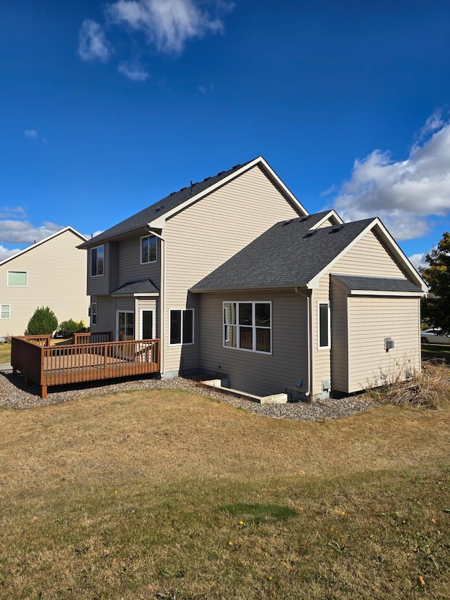 back of house featuring a wooden deck and a lawn