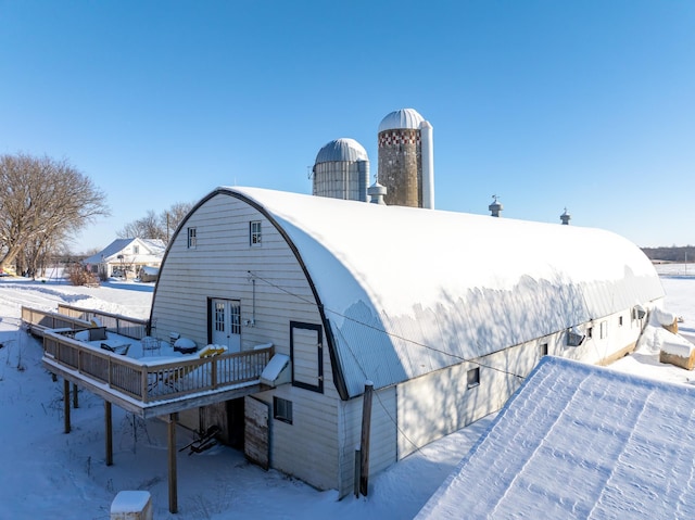 snow covered property featuring a wooden deck