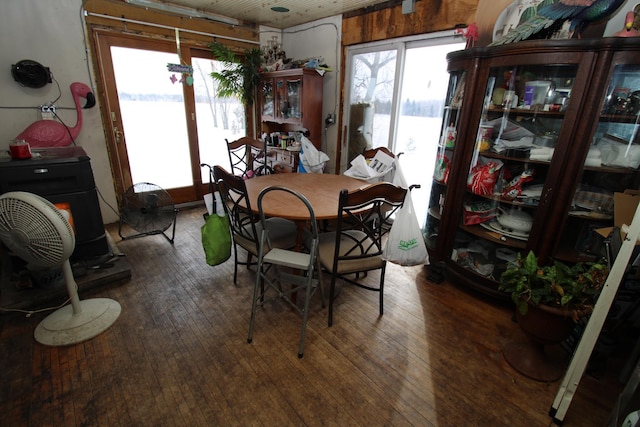 dining area featuring a water view, dark hardwood / wood-style floors, and a wealth of natural light