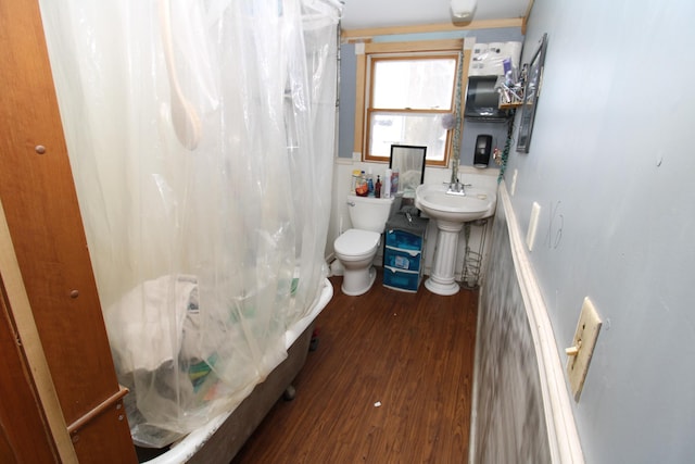 full bathroom with shower / tub combo with curtain, sink, toilet, and hardwood / wood-style floors