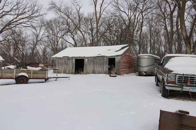 snow covered structure featuring an outdoor structure