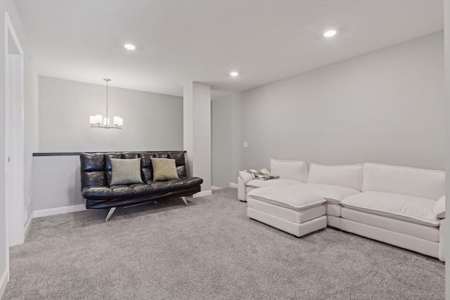 carpeted living room featuring baseboards, an inviting chandelier, and recessed lighting