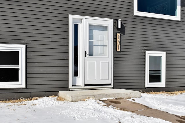 view of snow covered property entrance