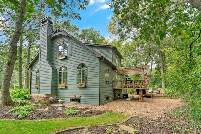 back of property with a pergola and a deck