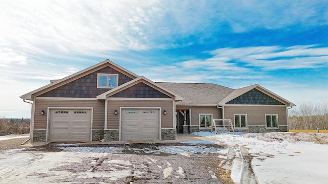 craftsman house featuring stone siding and an attached garage