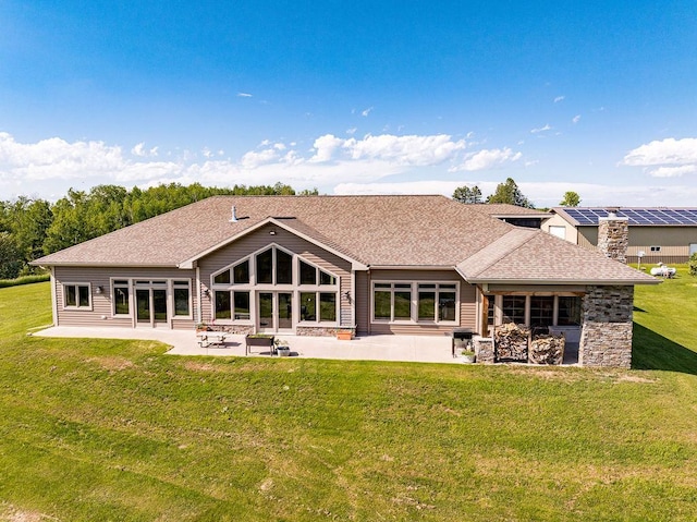 1036 Ziebarth Rd, Wrenshall, MN 55797 - rear view of property with a patio, a yard, a shingled roof, and a chimney