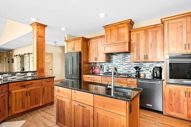 1036 Ziebarth Rd, Wrenshall, MN 55797 - kitchen with stainless steel appliances, dark stone counters, light wood-style flooring, backsplash, and recessed lighting