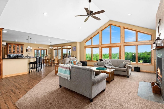 1036 Ziebarth Rd, Wrenshall, MN 55797 - living area featuring recessed lighting, high vaulted ceiling, wood finished floors, ceiling fan, and a fireplace with flush hearth