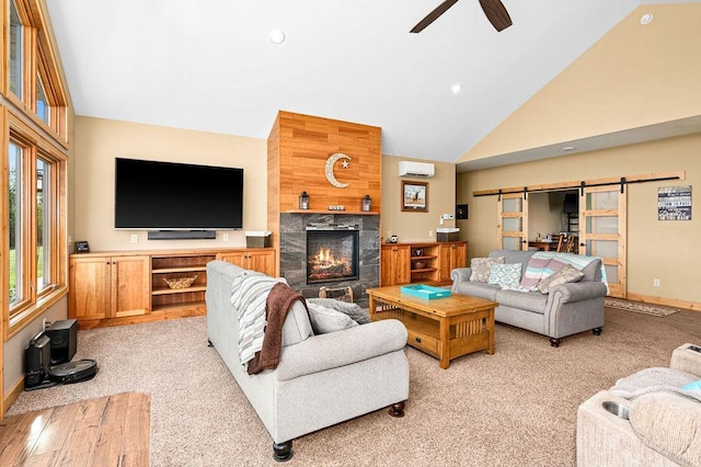 1036 Ziebarth Rd, Wrenshall, MN 55797 - living room with a barn door, ceiling fan, light carpet, a tile fireplace, and high vaulted ceiling