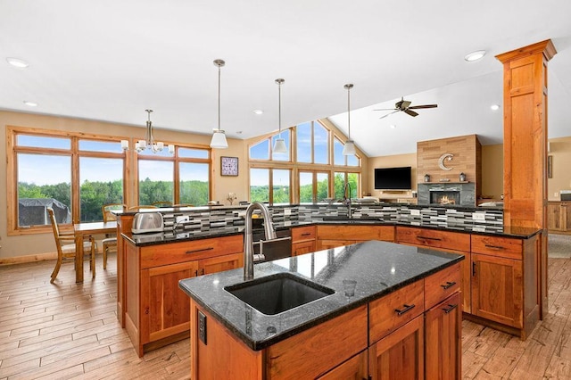 1036 Ziebarth Rd, Wrenshall, MN 55797 - kitchen with a center island with sink, ceiling fan, decorative backsplash, light wood-style flooring, and lofted ceiling